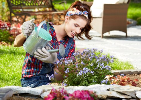 Close-up of a gardener assessing soil and plant health for maintenance work